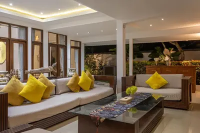 a living room with a couch and yellow pillows at 3 BR Villa in d' centre Seminyak in Seminyak