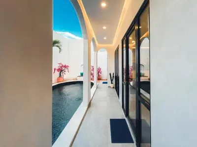 an internal view of a house with a swimming pool at Villa Paros 3BR Greek Island Villa in Seminyak in Seminyak