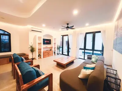 a living room with a couch and a table at Villa Paros 3BR Greek Island Villa in Seminyak in Seminyak