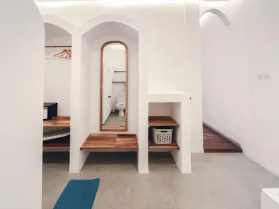 a white room with a mirror and a toilet at Villa Paros 3BR Greek Island Villa in Seminyak in Seminyak