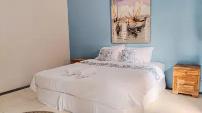 a bedroom with two beds with towels on the bed at JOJOBY sunset villa in Seminyak