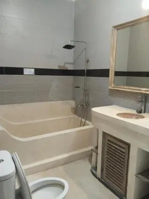 a bathroom with a tub and a sink and a toilet at JOJOBY sunset villa in Seminyak