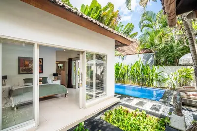 a bedroom in a villa with a pool at Zen Villas by iBali Management in Kerobokan