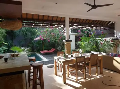 a living room with a table and chairs and a pool at Seminyak Beach Villa Ashira SUPERB Location in Seminyak