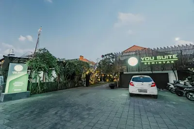 a white car parked in front of a building at You Suite Seminyak in Legian