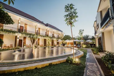 a pool in the courtyard of a building at You Suite Seminyak in Legian