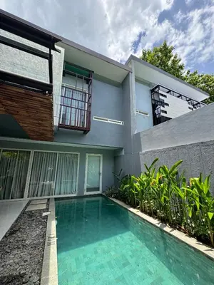 a house with a swimming pool in front of it at 2 BR Bougenville Villa in Nusa Dua