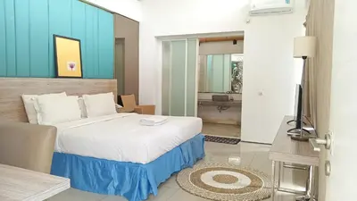 a bedroom with a bed and a television in a room at 2 BR Bougenville Villa in Nusa Dua
