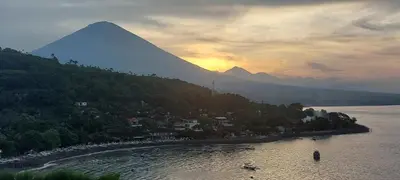a mountain sitting next to a body of water at Villa Pool Private and Romantic In Kuta Bali in Kuta