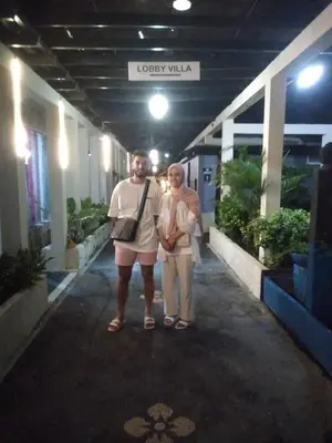 a man and a woman standing in front of a building at Villa Pool Private and Romantic In Kuta Bali in Kuta