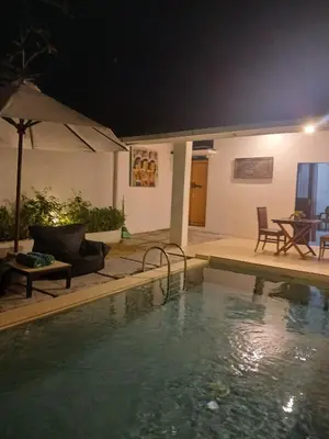 a swimming pool in a backyard at night at Villa Pool Private and Romantic In Kuta Bali in Kuta