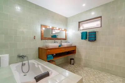 a bathroom with a tub and a sink and a mirror at Villa Santai pour 4 personnes à Seminyak in Seminyak