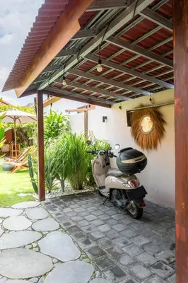 a motor scooter parked under a pergola at Villa Santai pour 4 personnes à Seminyak in Seminyak
