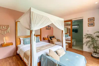 a bedroom with a canopy bed and a bathroom at Villa Santai pour 4 personnes à Seminyak in Seminyak