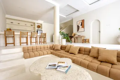 a living room with a couch and a table at Casa De La Vida in Legian