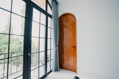 an open door in a room with windows at Sari Buana Villa Nusa Dua in Nusa Dua