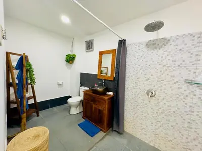 a bathroom with a toilet and a sink and a shower at Tiga Kelapa Villa by Smart Digital in Legian