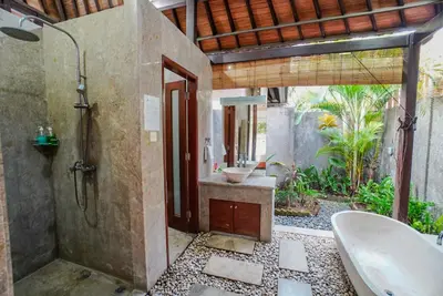 a bathroom with a shower and a sink and a tub at Villa Di Bucu, Canggu in Canggu