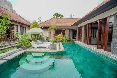 a swimming pool in front of a house at Villa Di Bucu, Canggu in Canggu