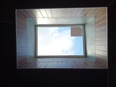 a window in a brick wall with the sky at 9 Residences Seminyak in Seminyak