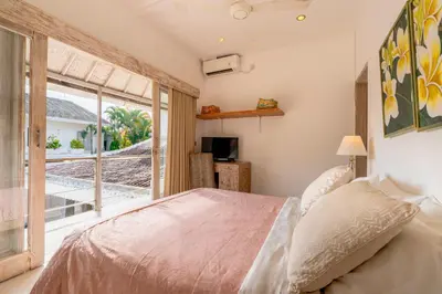 a bedroom with a bed and a large window at Villa Bella Vista by Pertama Management in Seminyak