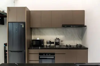 a kitchen with a stove and a refrigerator at Luxury Haven Stunning 2Br in Umalas Canggu in Kerobokan