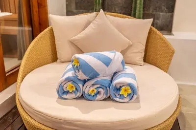 a pile of towels sitting on a wicker chair at Umasuka Villa in Denpasar