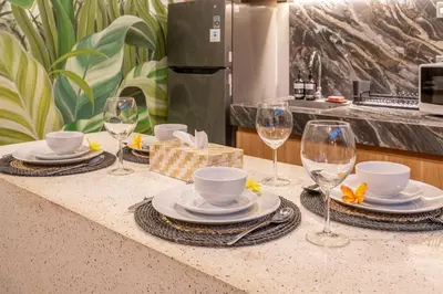 a table with plates and wine glasses on a counter at Umasuka Villa in Denpasar