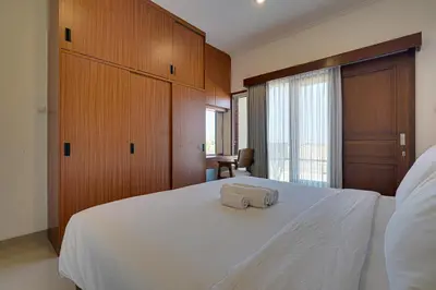 a bedroom with a white bed with a towel on it at Villa Taman Seminyak 46 Near Double Six Beach in Seminyak