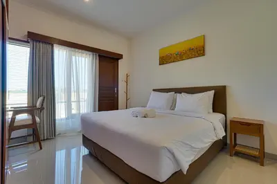 a bedroom with a bed with a stuffed animal on it at Villa Taman Seminyak 46 Near Double Six Beach in Seminyak