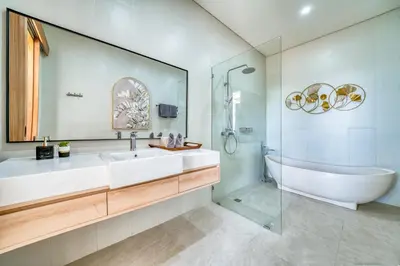 a bathroom with a tub and a sink and a bath tub at Villa Kangla - 3BR Luxurious Villa Seminyak in Seminyak