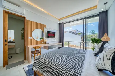 a bedroom with a bed and a desk with a mirror at Villa Kangla - 3BR Luxurious Villa Seminyak in Seminyak