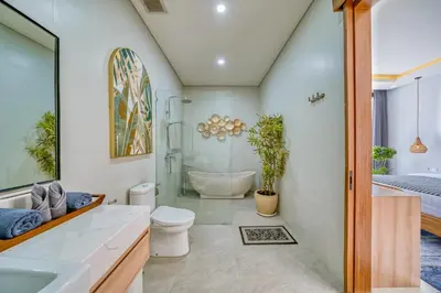 a bathroom with a toilet and a shower and a sink at Villa Kangla - 3BR Luxurious Villa Seminyak in Seminyak