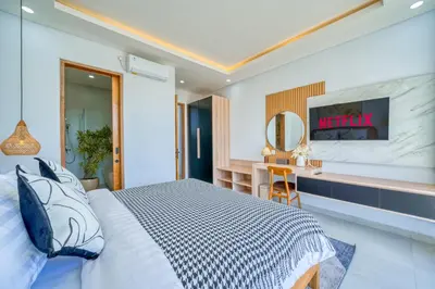 a hotel room with a bed and a desk at Villa Kangla - 3BR Luxurious Villa Seminyak in Seminyak