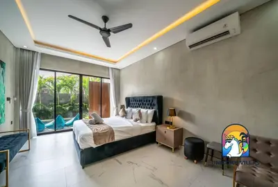 a bedroom with a bed and a ceiling fan at SOHO Seminyak 1 - by Unicorn Villas Bali in Seminyak
