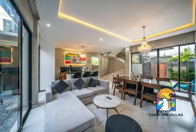 a living room with a couch and a table at SOHO Seminyak 1 - by Unicorn Villas Bali in Seminyak