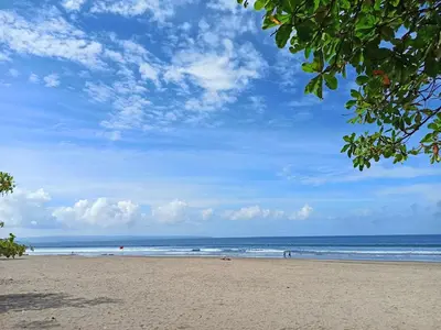 a beach with a blue sky and the ocean at Jayakarta Bali Apartment 6417 in Seminyak