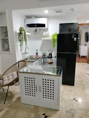 a kitchen with a black refrigerator and a counter at Jayakarta Bali Apartment 6417 in Seminyak