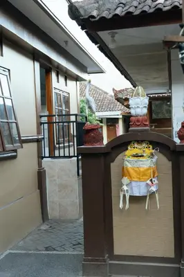 a table sitting on top of a wall next to a building at Dara House in Kuta