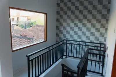 a room with a staircase with a window at Dara House in Kuta
