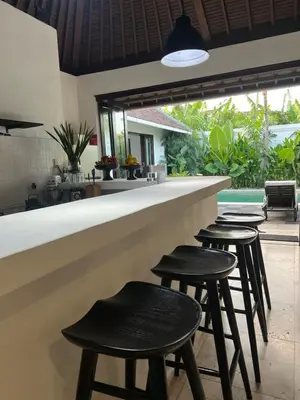 a bar with four stools in front of it at The Mia Bali in Kerobokan