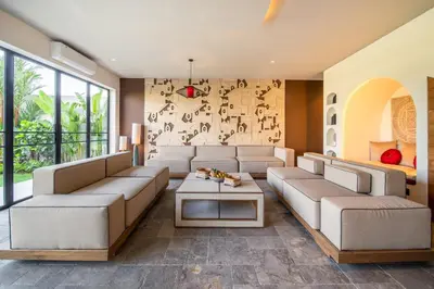 a living room with a couch and a table at Villa Charleston Umalas in Kerobokan