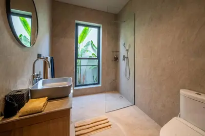 a bathroom with a sink and a shower at Villa Charleston Umalas in Kerobokan