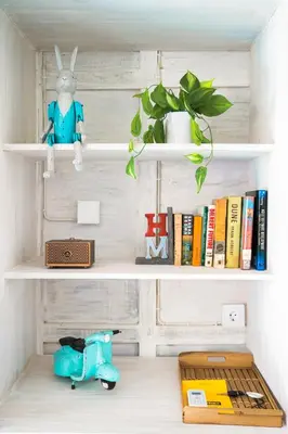 a shelf with a toy rabbit and books at SooBali Mint Cottage Sanur 1BR in Sanur