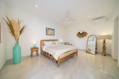 a bedroom with a bed and a blue vase at Kubung 2 - Perfect Retreat in Canggu in Kerobokan