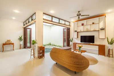 a living room with a couch and a television at Seven Residence in Seminyak