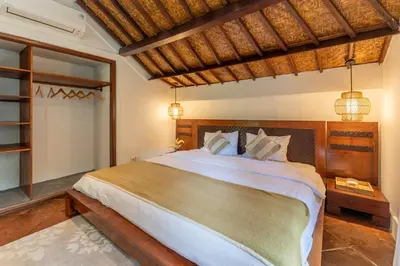 a bedroom with a large bed in a room at Jungle Wave Villa in Central Seminyak in Seminyak