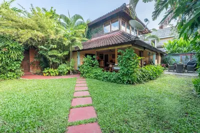 a house with a garden and a brick path at Jungle Wave Villa in Central Seminyak in Seminyak