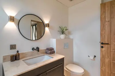 a bathroom with a sink and a mirror at Villa Moana - Incredible 2BR Villa Next To The Beach in Canggu in Canggu