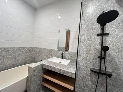 a bathroom with a sink and a bath tub at Della Rossa in Seminyak